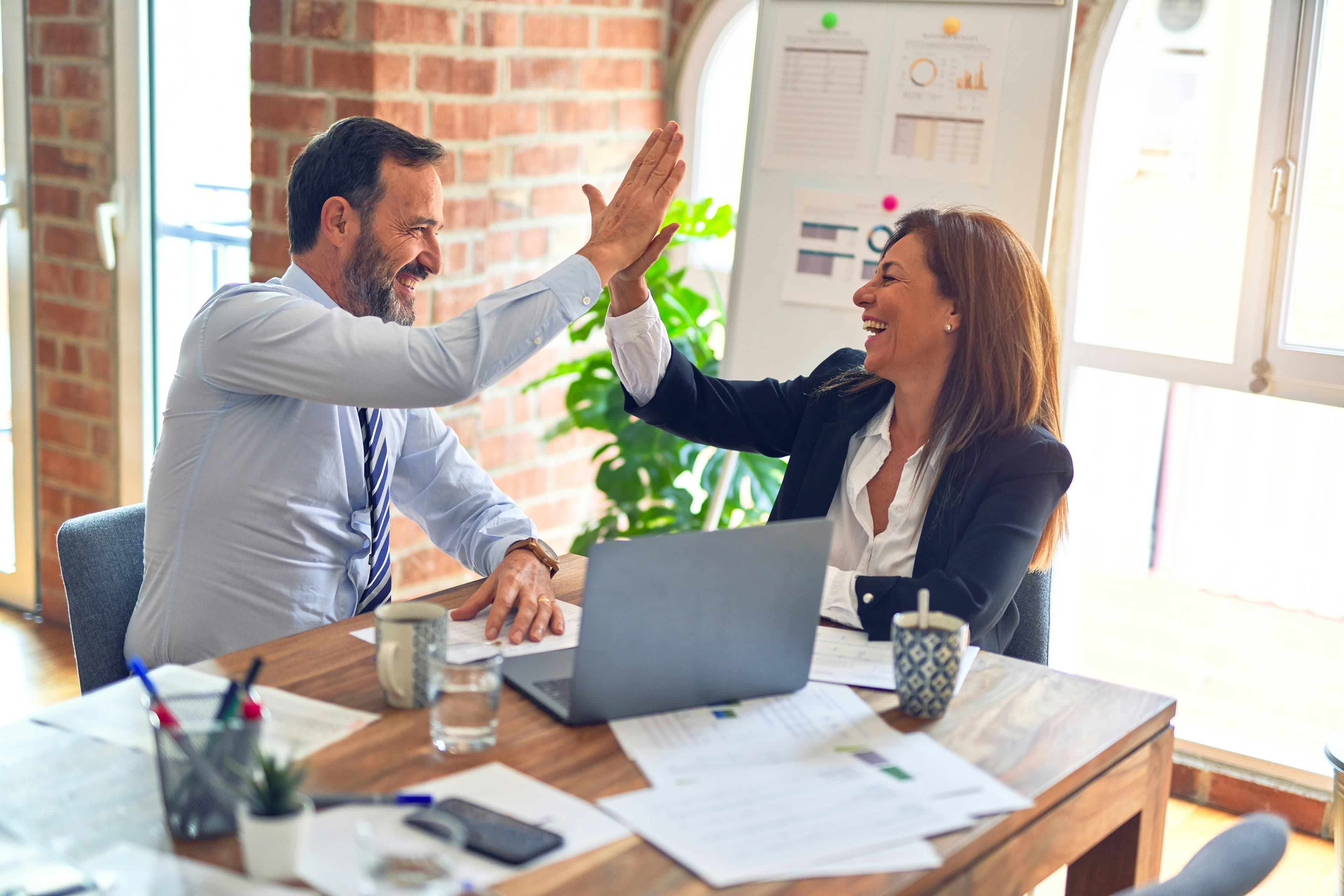 Business professionals reviewing procurement outcomes